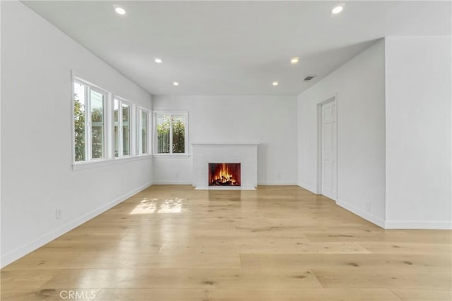 unfurnished living room featuring light wood-type flooring