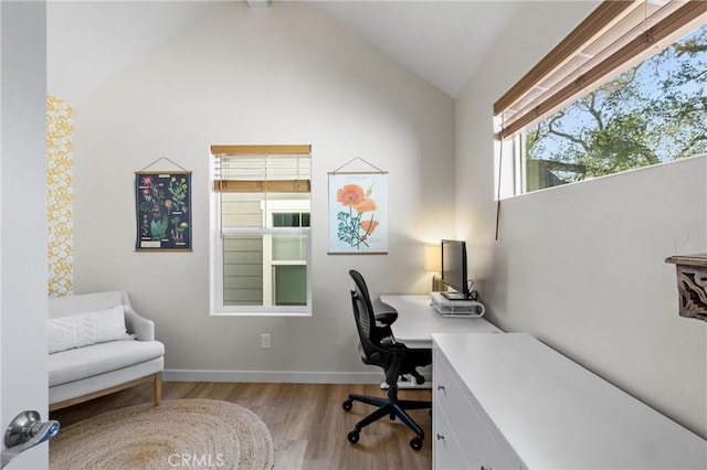 office area with baseboards, vaulted ceiling, and wood finished floors