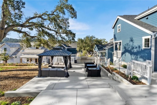 exterior space with an outdoor hangout area, a gazebo, a patio, and a residential view