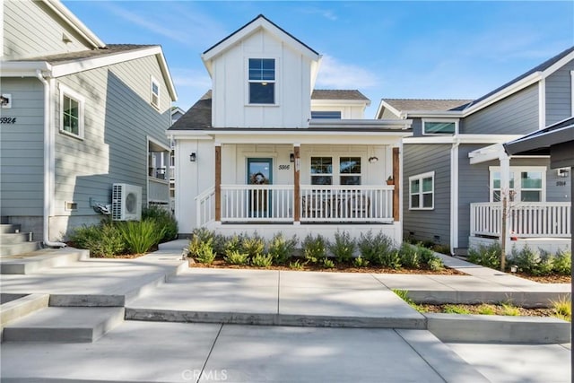 view of front of house featuring a porch and ac unit