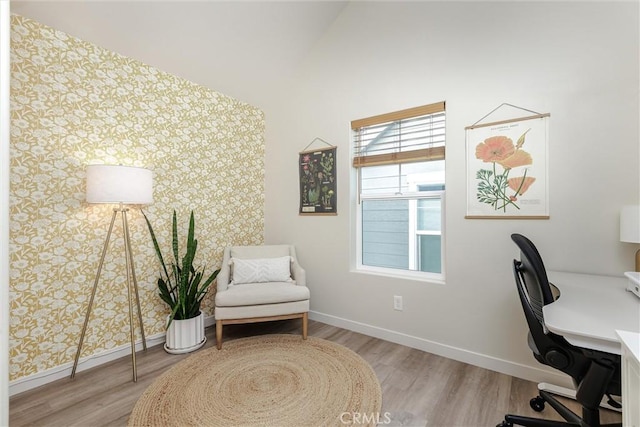 office space with lofted ceiling, wood finished floors, and baseboards