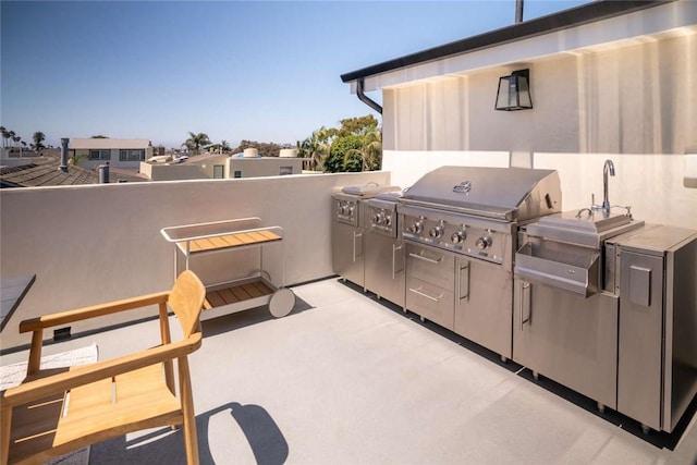 view of patio featuring area for grilling and exterior kitchen