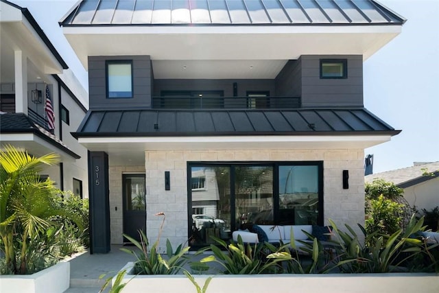 rear view of house featuring a balcony