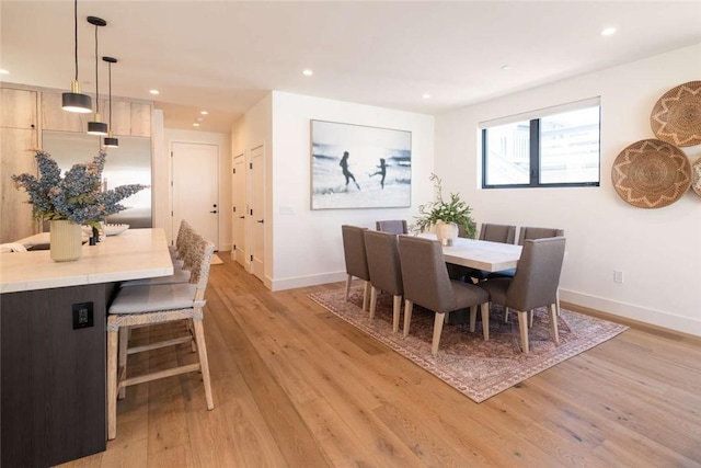 dining space with light hardwood / wood-style floors