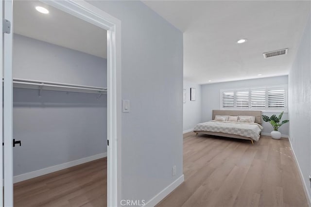 bedroom featuring light hardwood / wood-style floors and a closet