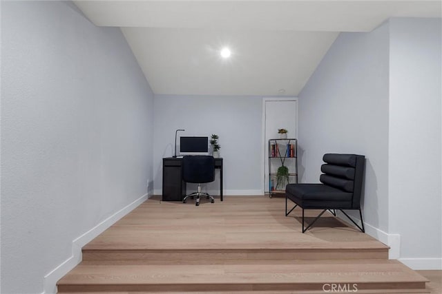 office space featuring hardwood / wood-style flooring and vaulted ceiling