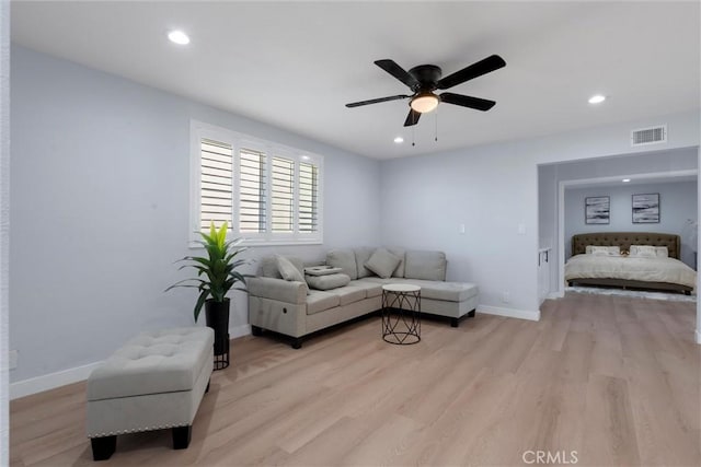 living room with ceiling fan and light hardwood / wood-style floors