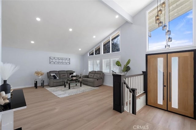 living room featuring high vaulted ceiling, beam ceiling, and light hardwood / wood-style floors