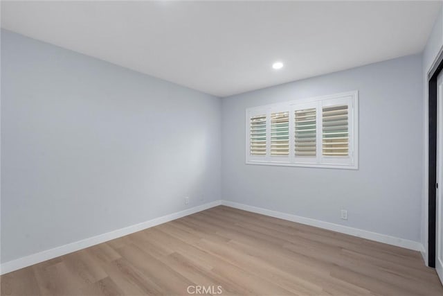 spare room with light hardwood / wood-style flooring