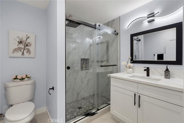 bathroom with tile patterned floors, vanity, toilet, and a shower with door