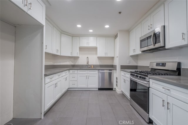 kitchen featuring sink, white cabinets, and appliances with stainless steel finishes