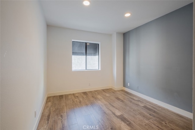 spare room with light hardwood / wood-style flooring