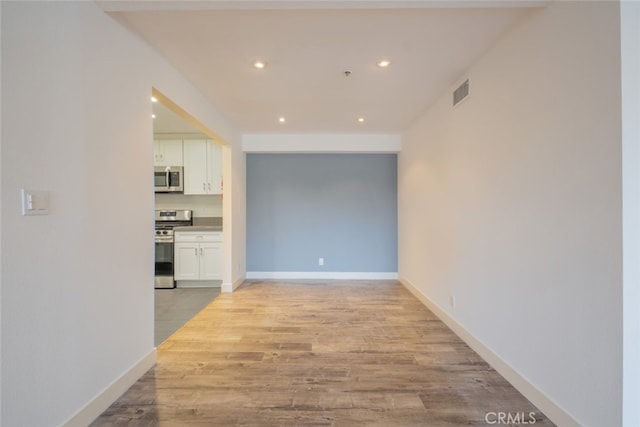 hallway with light hardwood / wood-style flooring