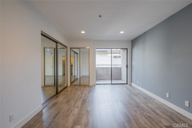 unfurnished room with hardwood / wood-style flooring