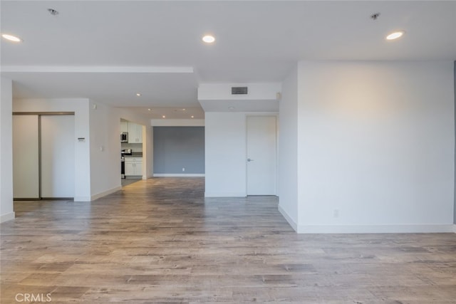 spare room with light hardwood / wood-style floors