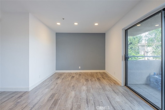 spare room featuring light hardwood / wood-style flooring