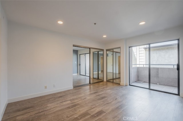 spare room featuring light hardwood / wood-style flooring