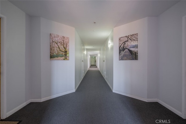 corridor featuring dark carpet