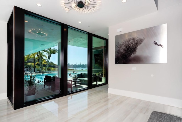 1095 Hoover St, Carlsbad, CA 92008 - tiled spare room featuring a wall of windows, recessed lighting, baseboards, and a water view