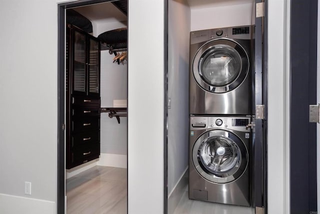 1095 Hoover St, Carlsbad, CA 92008 - laundry room with stacked washer and clothes dryer and baseboards
