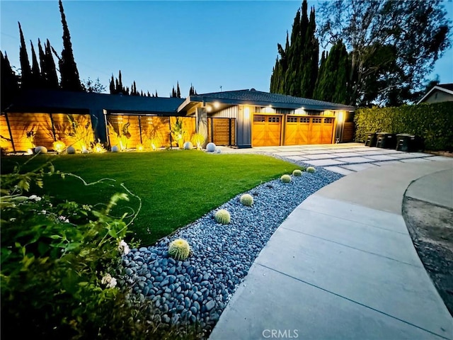 view of front facade with a garage and a front lawn