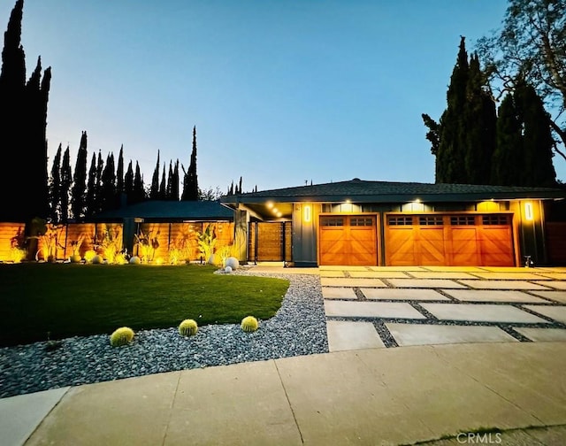 view of front of property with a yard and a garage