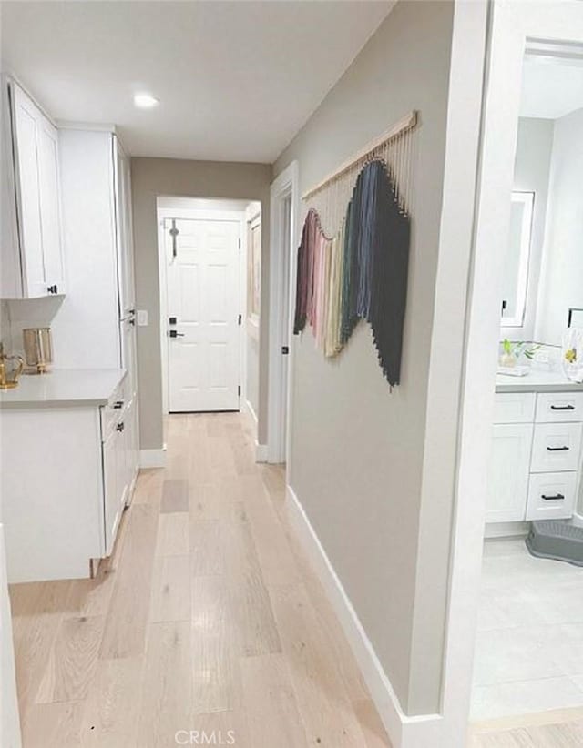 hallway with light hardwood / wood-style flooring