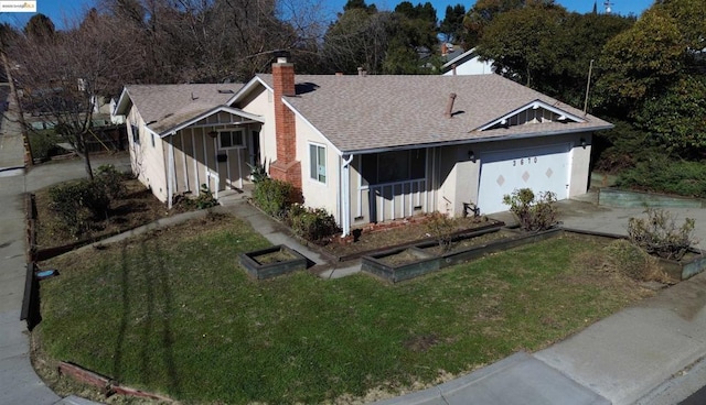 view of front of home with a front yard and a garage