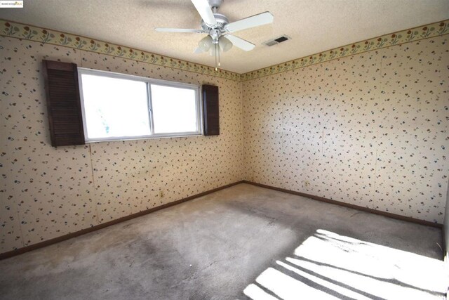 unfurnished room featuring carpet floors, ceiling fan, and a textured ceiling