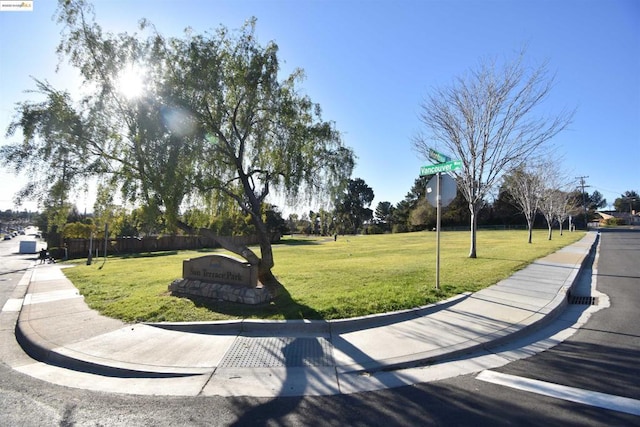 view of home's community with a yard