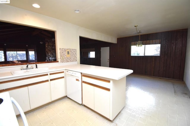 kitchen featuring kitchen peninsula, sink, white cabinetry, and dishwasher