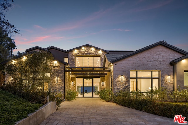 view of back house at dusk