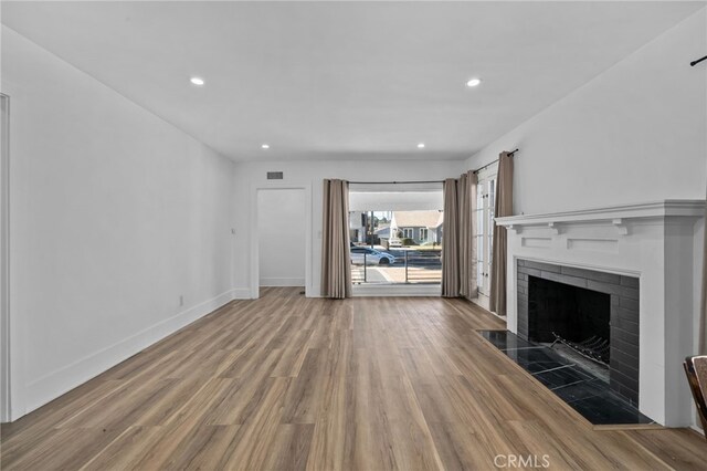 4816 7th Ave, Los Angeles, CA 90043 - unfurnished living room featuring wood finished floors, a fireplace, recessed lighting, and baseboards
