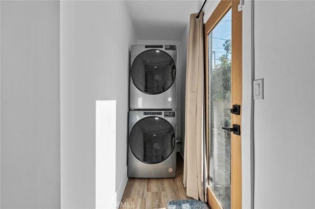 4816 7th Ave, Los Angeles, CA 90043 - washroom with estacked washer and dryer, wood finished floors, and baseboards
