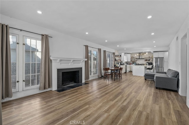 4816 7th Ave, Los Angeles, CA 90043 - living room with recessed lighting, a fireplace with flush hearth, and light wood-type flooring