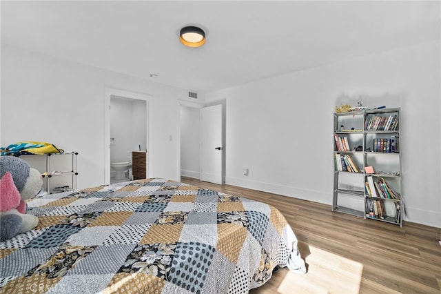 4816 7th Ave, Los Angeles, CA 90043 - bedroom with wood finished floors, baseboards, and ensuite bath
