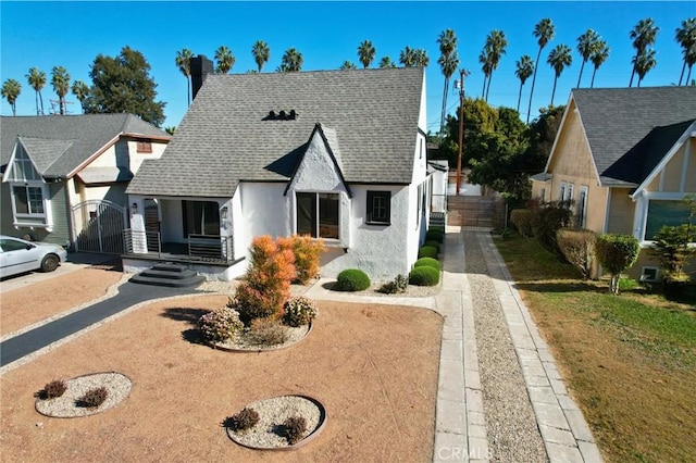 4816 7th Ave, Los Angeles, CA 90043 - view of front of house featuring stucco siding, a chimney, roof with shingles, and fence