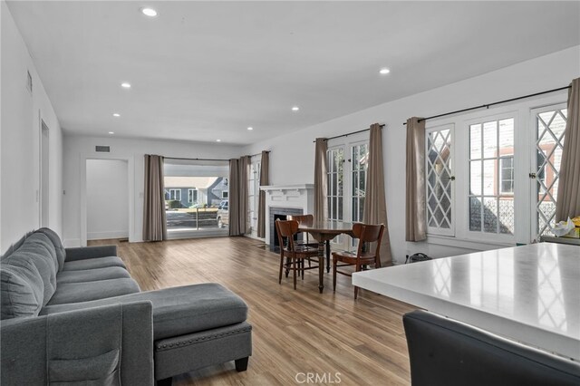 4816 7th Ave, Los Angeles, CA 90043 - living room featuring recessed lighting, plenty of natural light, a fireplace with flush hearth, and light wood-type flooring