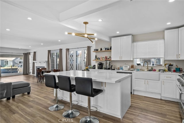 4816 7th Ave, Los Angeles, CA 90043 - kitchen featuring a sink, open floor plan, a kitchen island, white cabinets, and light countertops