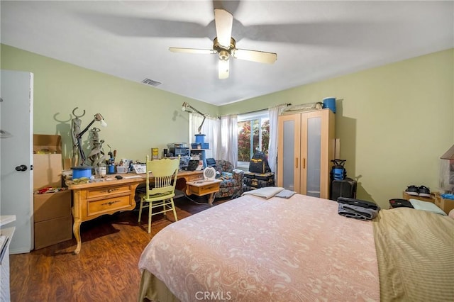 bedroom with ceiling fan and dark hardwood / wood-style flooring