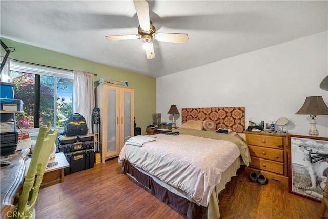 bedroom with ceiling fan and dark hardwood / wood-style flooring