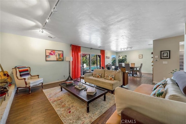 living room with track lighting and dark hardwood / wood-style floors