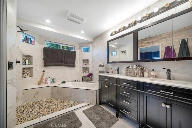 bathroom featuring backsplash, a bath, vanity, and tile walls