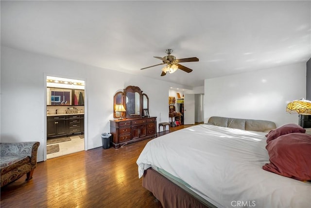 bedroom with ceiling fan, connected bathroom, and dark hardwood / wood-style floors