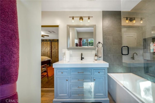 bathroom with vanity, independent shower and bath, and hardwood / wood-style floors