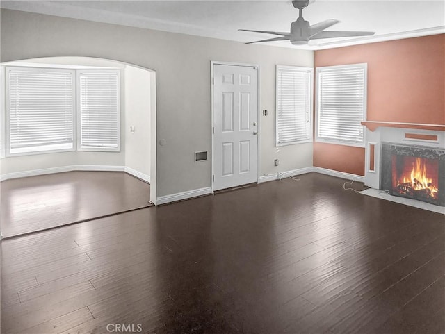 unfurnished living room featuring dark hardwood / wood-style floors and ceiling fan