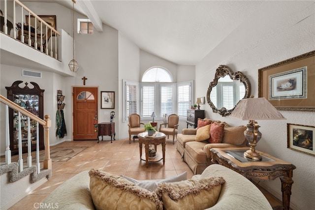 tiled living room with high vaulted ceiling