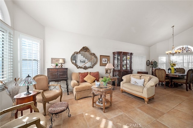 living room with a notable chandelier, vaulted ceiling, and light tile patterned floors