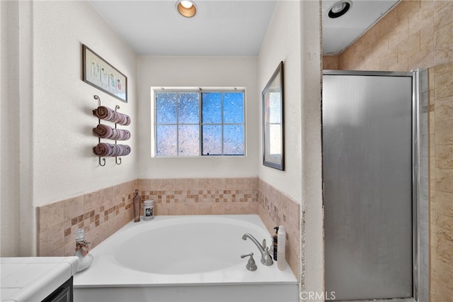 bathroom featuring separate shower and tub and vanity