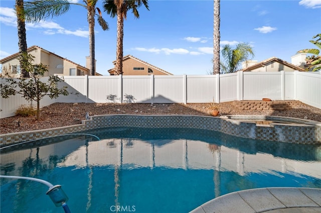 view of pool with an in ground hot tub